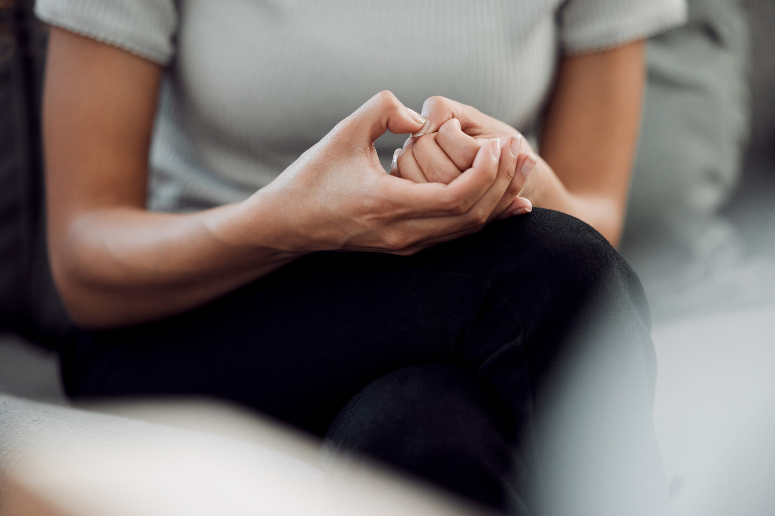 A woman sitting with hands on knees. OCD therapy in American Fork, UT is here for you. We offer OCD treatment so you can get the support you deserve.
