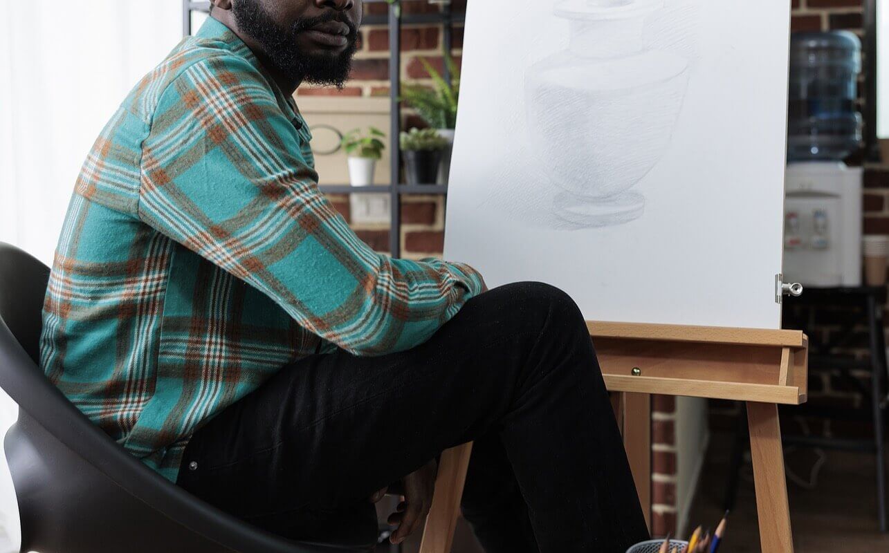 An adult man sitting with his drawing of a vase. Depression treatment in American Fork, UT is ready to support you. Learn the different depression treatments here.