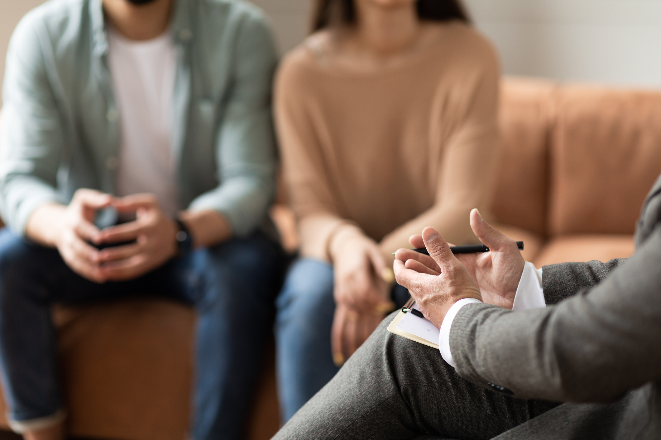 Couple sitting In office attending marriage counseling. With a couples therapist in American Fork, UT, your relationship can thrive again. Call today to learn more.