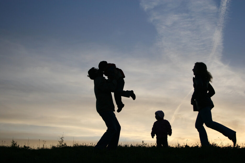 A silhouette of a family. Did you know we have faith transition therapy in American Fork, UT? Call us today to get started with faith deconstruction therapy.