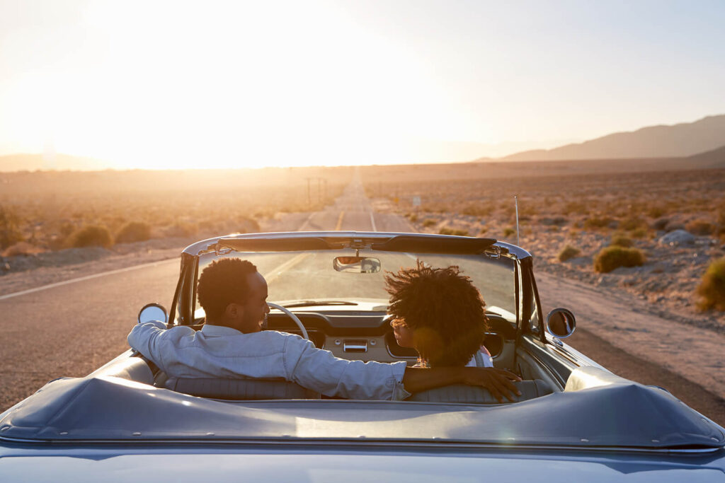 A married couple driving down a road. Let your marriage thrive with the help of an American Fork, UT marriage counselor. Contact us today to begin couples therapy. 