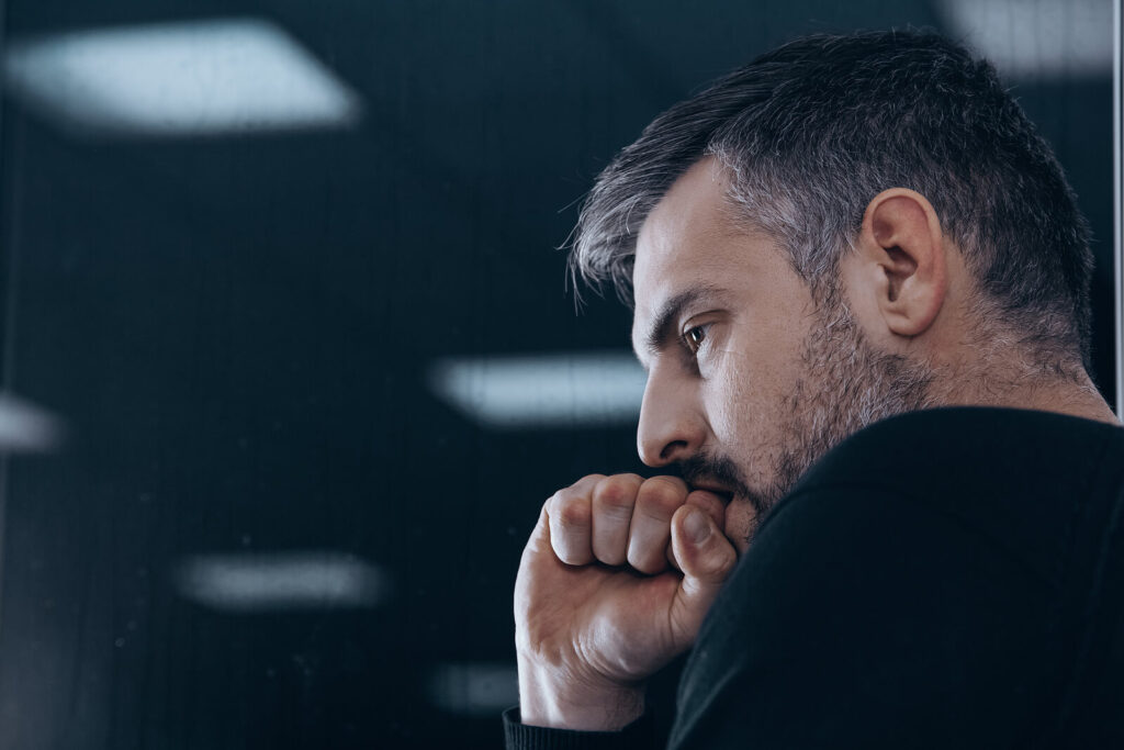 A  man appears stressed with his hand in a fist against his mouth. Learn how anxiety treatment in American Fork, UT can help you cope with anxious symptoms. Search for "therapist American Fork" to learn more about how an anxiety therapist American Fork, UT can help. 

