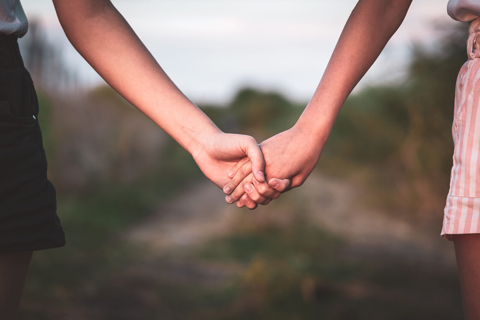 A close-up of a couple holding hands while standing outside. Learn how couples counseling in American Fork, UT can offer support for couples creating stronger relationships. Search for a therapist for couples American Fork, UT to learn more.