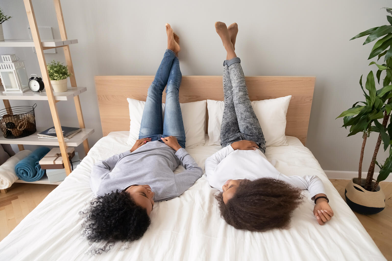 A mother and their teen daughter talk while laying on a bed. Learn more about therapy for teens in American Fork, UT and how it can help cultivate deeper bonds. Learn more about teenage counseling Utah by searching for teenage therapy near me.