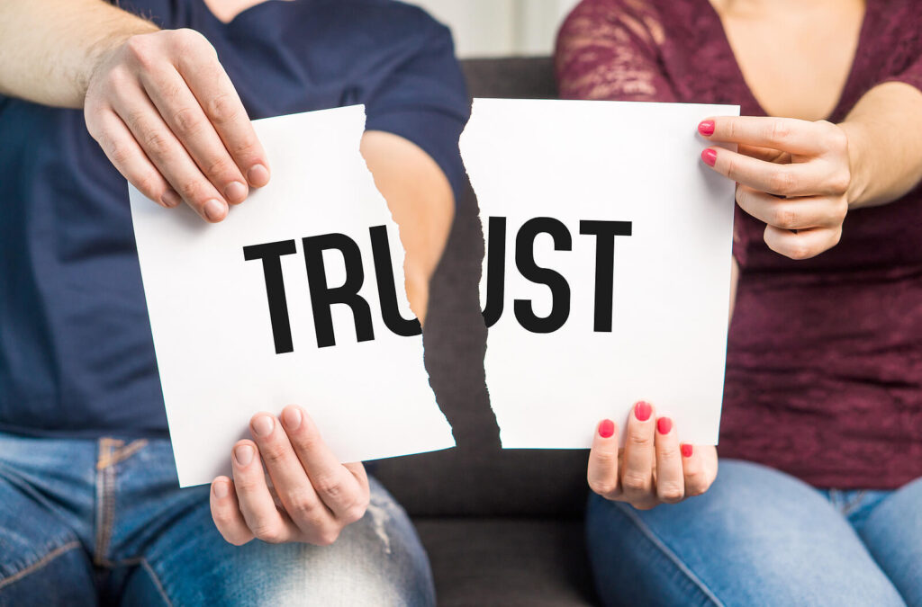 A close up of a paper with the word Trust printed that is torn in two. This could symbolize the lack of trust after relationship betrayal that couples therapy in American Fork, UT can address. Learn more about couples counseling American Fork, UT by searching for attachment trauma in American Fork, UT today.