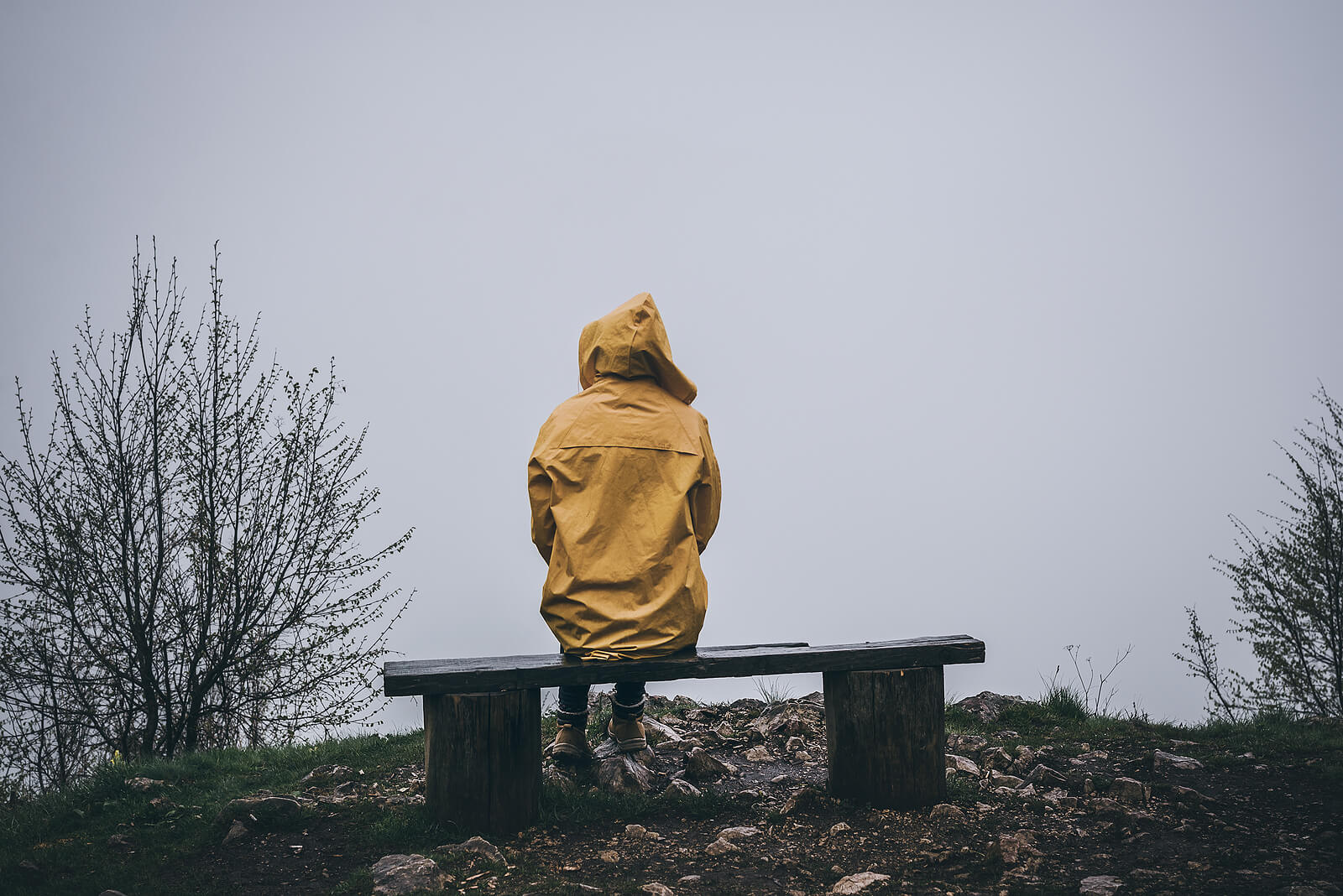 A person sits alone on a bench on a foggy day while wearing a jacket. Learn how therapy for depression in American Fork, UT can help you address signs of depression. Contact anxiety and depression therapists in American Fork for more info.